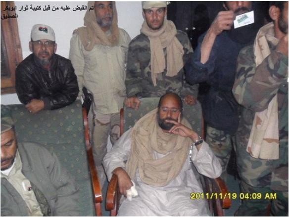 Saif Gaddafi khi vừa bị bắt với cánh tay bị thương do một trận không kích của NATO hơn tháng trước